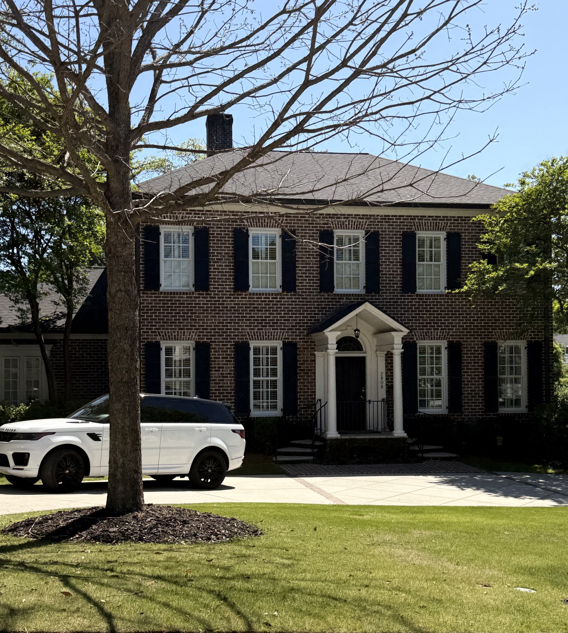 Brick Georgian Colonial home with a pedimented portico entry and circular drive, Augusta, Georgia, architectural photography by Nelson White