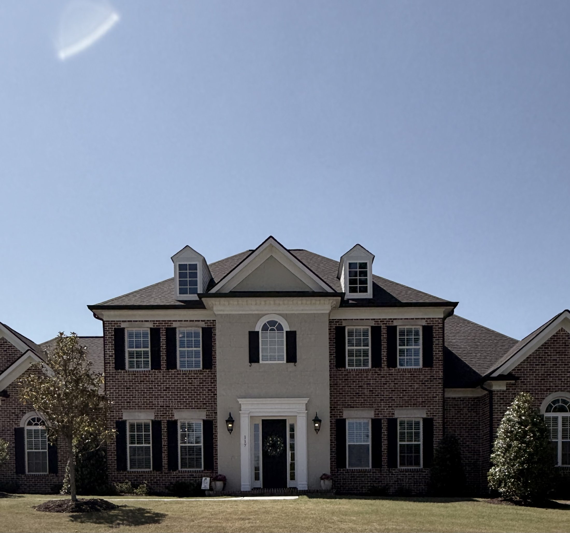 Symmetrical brick Georgian Colonial with a columned entrance and clipped front shrubs, Augusta, Georgia, architectural photography by Nelson White