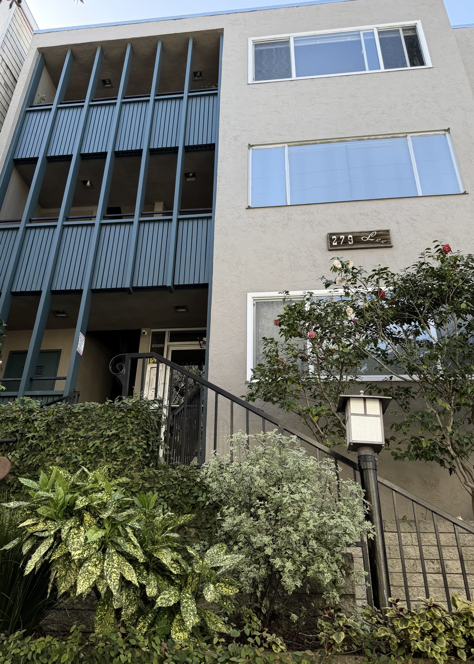 Mid-century modern condominium with blue glass balconies and an exterior staircase, Bay Area, California, architectural photography by Nelson White